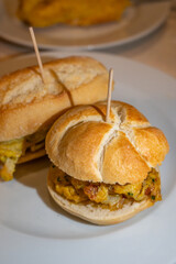 Typical mini burger snack of Basque Country, pinchos or pinxtos, small piece of bread with different toppings, served in bar in San-Sebastian or Bilbao, Spain