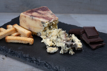 Cheese collection, blue stilton English cheese matured in red porto wine served as dessert with walnuts and chocolate
