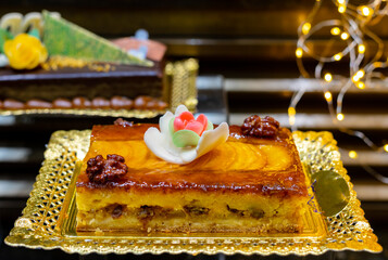 Delicious fresh baked colorful decorated cakes, tarts with cream and fruits on display in bakery in Bilbao, Basque Country, Spain