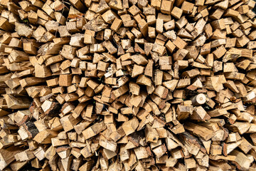 Photography on theme big wall of stacked oak tree logs in cracks
