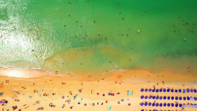 Drone are flying over tourists sunbathing and relaxing on the beach in Phuket, Famous tourist attractions in Southeast Asia, Thailand. sea background. Drone. Amazing high quality stock video. 4K
