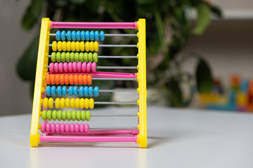 Colorful children's abacus on the table. Mathematics, arithmetic for preschool and school children, learning to count