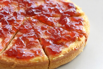 Strawberry jam pizza on a plate. 