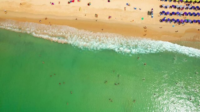 Drone are flying over tourists sunbathing and relaxing on the beach in Phuket, Famous tourist attractions in Southeast Asia, Thailand. sea background. Drone. Amazing high quality stock video. 4K
