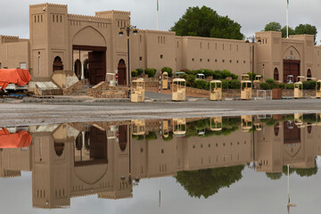  A view of the gates of Nizwa market with a beautiful reflection of water