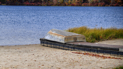 Row boat on dock on beach for winter