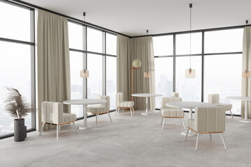 Stylish cafe interior with tables and chairs near panoramic window