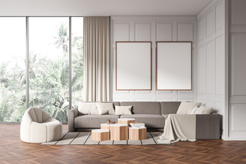 Fototapeta na wymiar Stylish living room interior with armchair and couch with decor, mockup frames