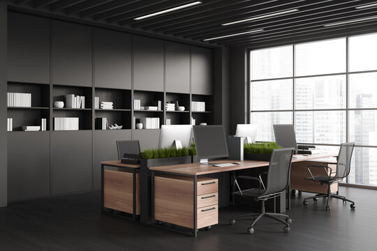 Black coworking interior with pc computer, shelf and panoramic window