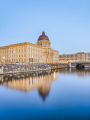 Fototapeta premium Berlin Humboldt Forum and its reflection on Spree canal surface at dusk, Germany
