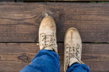 yellow autumn boots, legs with boots, denim pants, leaves scattered on the ground, yellow leaves, autumn sidewalk