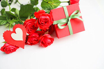 red roses and gift box on white
