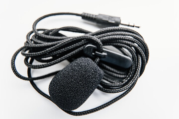 Buttonhole on a white background. Compact microphone for audio recording.