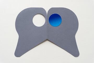 paper shape with holes (one blank, one with a blue circle)