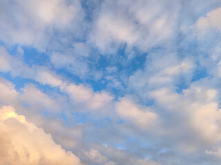 Blue sky clouds background. Beautiful landscape with clouds and orange sun on sky