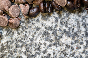 Coffee Beans and Chocolate Chips as a background pattern on marble