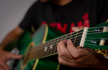 Close up of hands playing guitar
