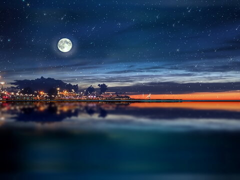  night sea water blurred city light,blue water wave  reflection  starry sky and moon in Italy  port harbor nature landscape