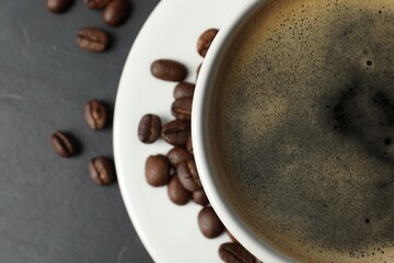 Cup of aromatic coffee on grey table, top view. Space for text