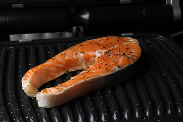Cooking salmon. Grill with fresh fish steak and spices