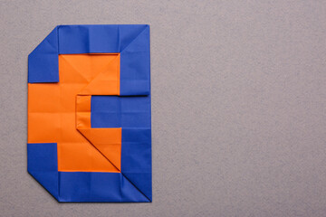 Number three made of paper on light brown background, top view