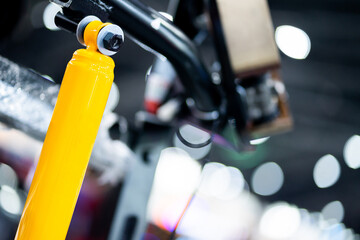 Yellow front shock absorber of a big bike motorcycle under the light