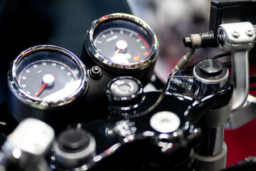 Horizontal close-up of the speedometer and tachometer of a vintage motorcycle