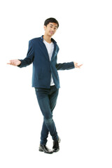 Asian teenage boy standing on white background Spread both hands to an empty space. - 557633019