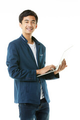 Young Asian teenage boy in casual clothes on a white background holding a laptop computer. - 557633023