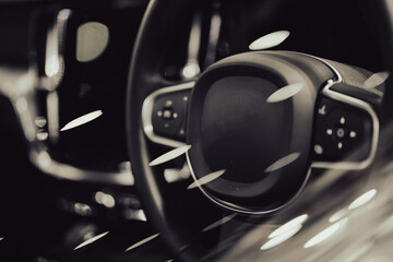 Modern luxury black car interior, steering wheel, modern car interior details, vintage tones