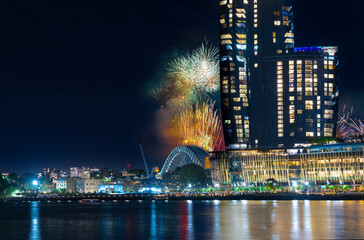 Fototapeta premium Sydney Harbour Bridge New Years Eve fireworks, colourful NYE fire works lighting the night skies with vivid multi colours NSW Australia. Happy New Year. New Year Eve