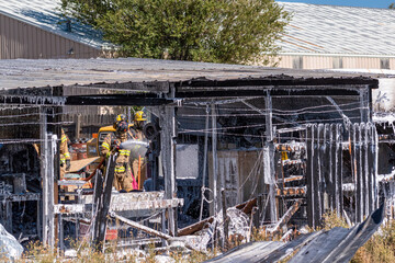 Firefighters battle a shed fire
