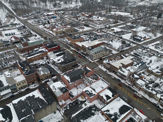 An aerial view of historic downtown Lebanon, Ohio, with Broadway Street visible in the center, is shown in an aerial view during a snowy winter day.
