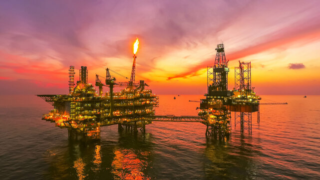 Areal photography from top view of jack up rig scenery with blue ocean view.