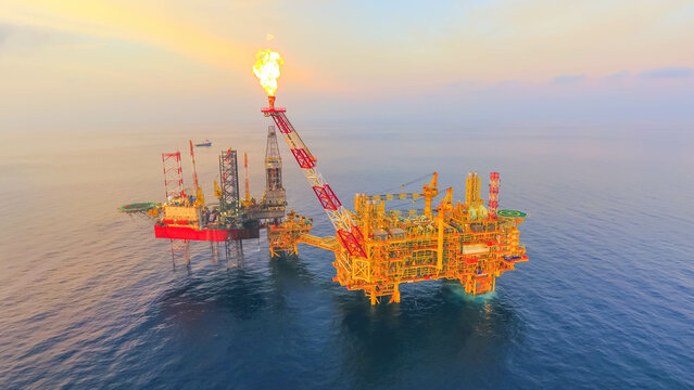 Areal photography from top view of jack up rig scenery with blue ocean view.