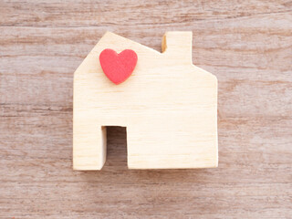 Top view house wooden toy with red heart on a rustic table. Home sweet home. Concept finance, insurance, lone..