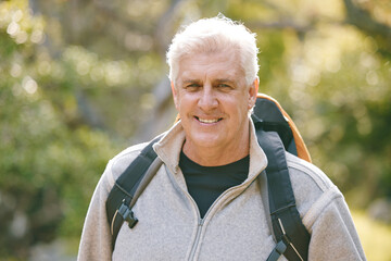 Hiking, fitness and elderly man in nature for exercise and trekking in the park, vitality and...