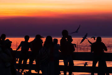 Fototapeta na wymiar Silhouette and red sky in New Year's Eve, sunset at Bang Pu Sea, Gulf of Thailand