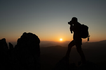 Men traveling as a backpacker enjoying the natural scenery, happiness, traveling on the top of the mountain. Watch the sunset with a large backpack. travel lifestyle summer adventure Outdoor travel 