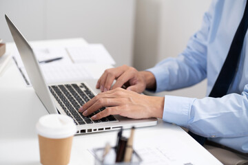 Business man working by using laptop computer Hands typing on a keyboard. Professional investor working new start up project. business planning in office. Technology business
