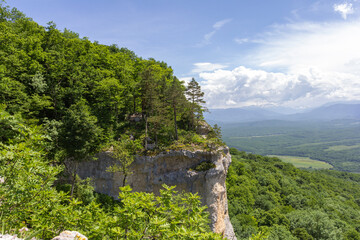 Summer, mountainous terrain, hiking trails running through the park, a place for walking and recreation.