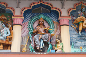 Fototapeta na wymiar Sculpture of the Hindu God Dharmaraj on the wall of hindu temple in Mayapur, India.