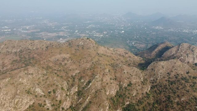 Bahubali Hills, Udaipur, Rajasthan, India 28th December 2022: Popular prewedding destination and trekking spot near Udaipur. 4k Aerial view of Bahubali hill and Badi lake near Barda village