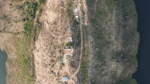 Bahubali Hills, Udaipur, Rajasthan, India 28th December 2022: Popular prewedding destination and trekking spot near Udaipur. 4k Aerial view of Bahubali hill and Badi lake near Barda village
