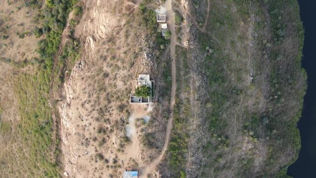 Bahubali Hills, Udaipur, Rajasthan, India 28th December 2022: Popular prewedding destination and trekking spot near Udaipur. 4k Aerial view of Bahubali hill and Badi lake near Barda village