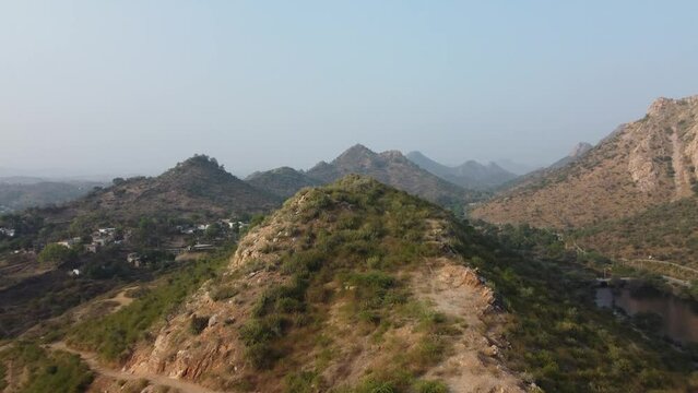 Bahubali Hills, Udaipur, Rajasthan, India 28th December 2022: Popular prewedding destination and trekking spot near Udaipur. 4k Aerial view of Bahubali hill and Badi lake near Barda village