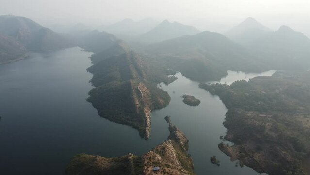 Bahubali Hills, Udaipur, Rajasthan, India 28th December 2022: Popular prewedding destination and trekking spot near Udaipur. 4k Aerial view of Bahubali hill and Badi lake near Barda village
