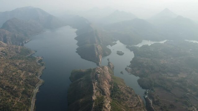 Bahubali Hills, Udaipur, Rajasthan, India 28th December 2022: Popular prewedding destination and trekking spot near Udaipur. 4k Aerial view of Bahubali hill and Badi lake near Barda village