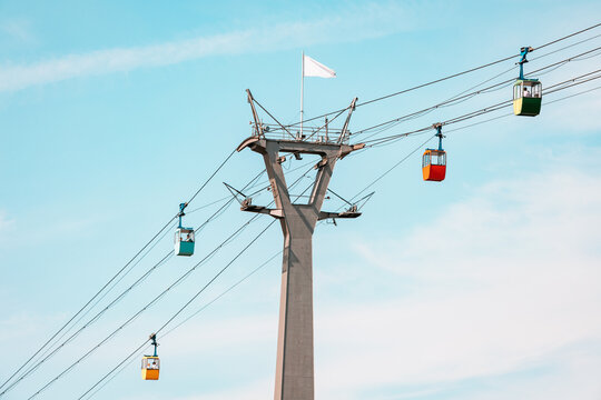 Cable car gondolas transporting tourists from station in Rheinpark in Cologne, Germany. Sightseeing and attractions concept