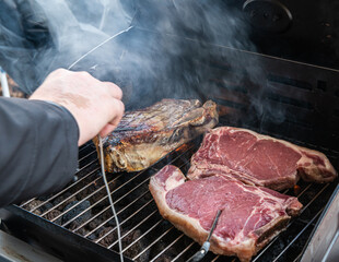 grilled t-bone Steak ( beef stead) on a barbecue with meat thermometer. Selective focus